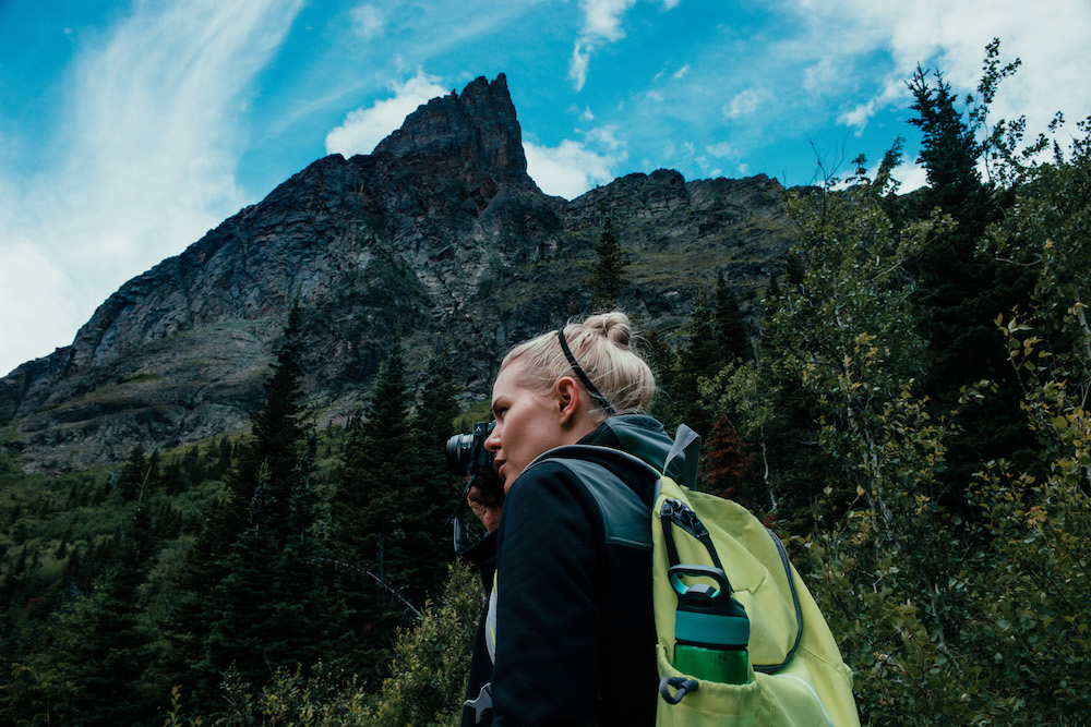 Woman taking a picture while hiking in Montana