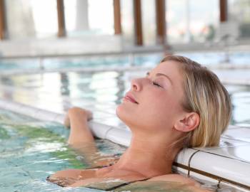 Woman relaxing in a heated spa