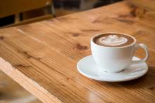 cup of coffee on a table at a coffee shop