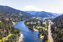 aerial view of winding river and a side road in the mountains of montana