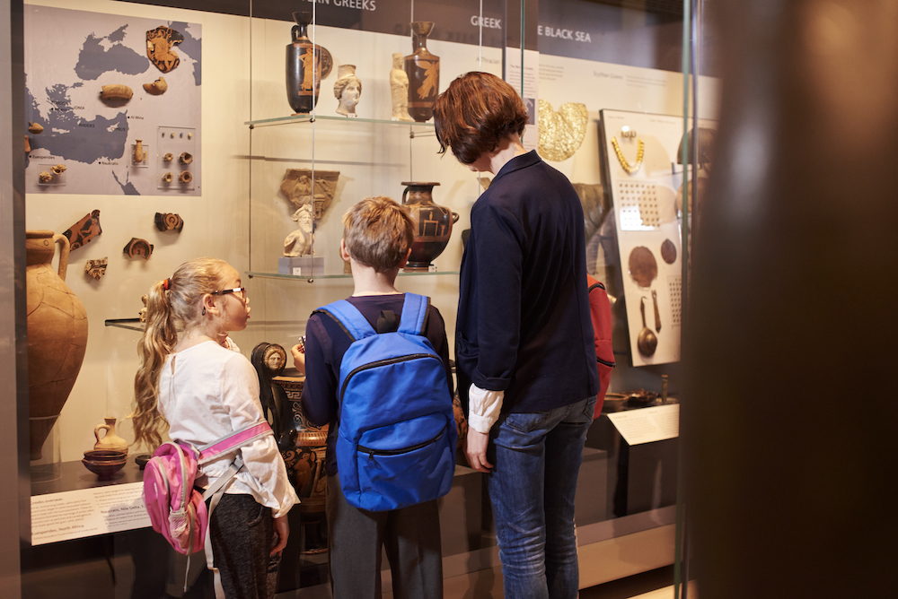 family looking at artifacts in a museum