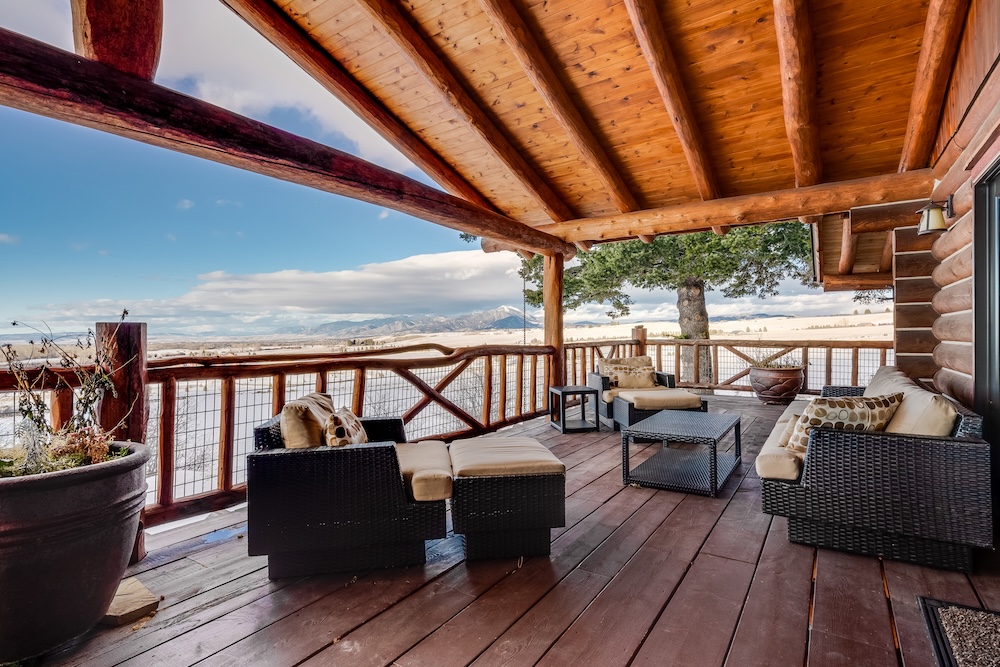 Vacation rental home deck with outdoor seating and expansive valley views